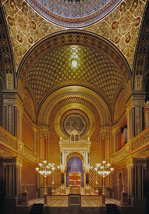 Gilded Moorish Revival interior of the Spanish Synagogue in Prague with its decorated dome and Torah ark